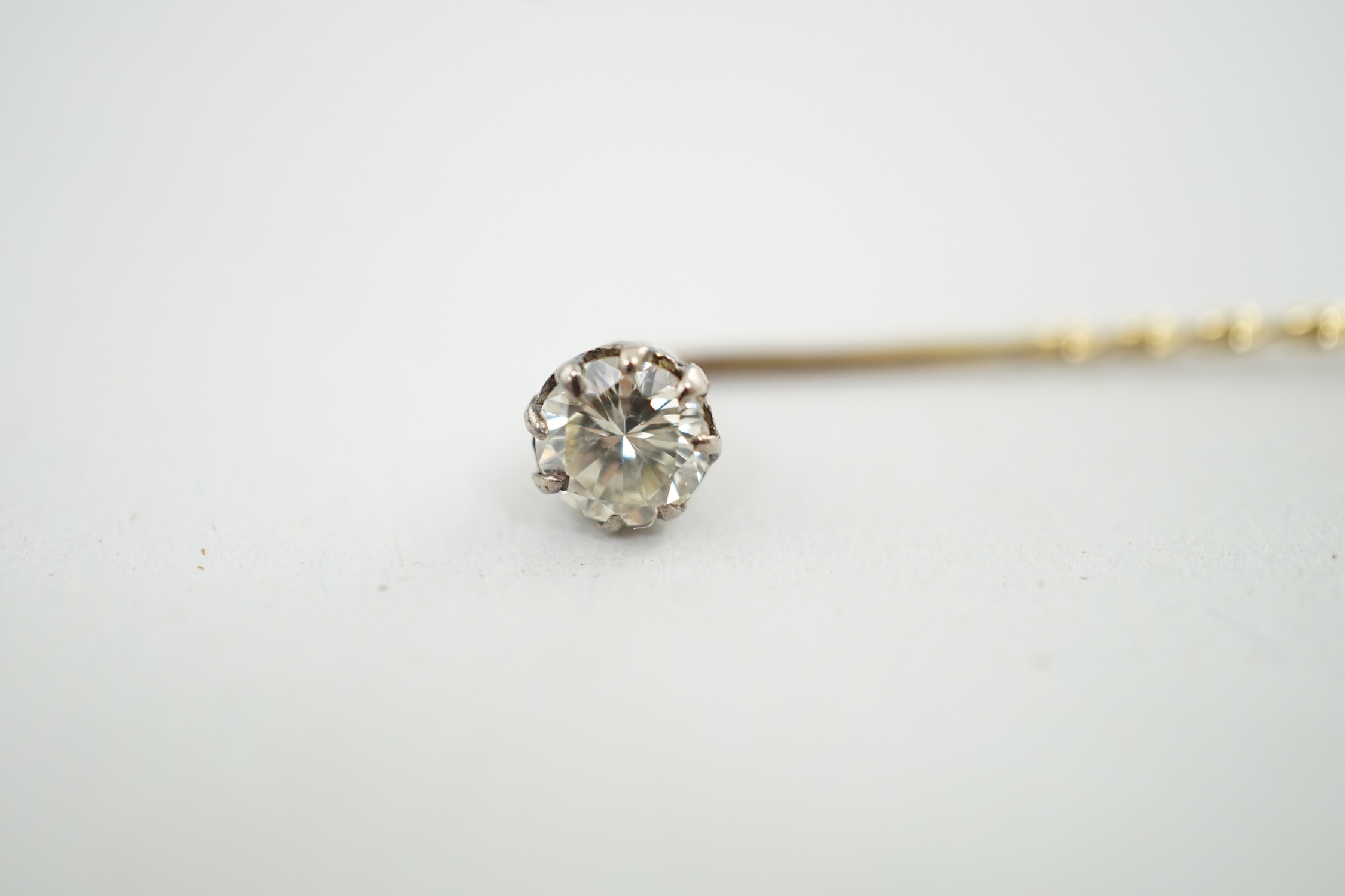 A late Victorian gold and solitaire diamond set stick pin